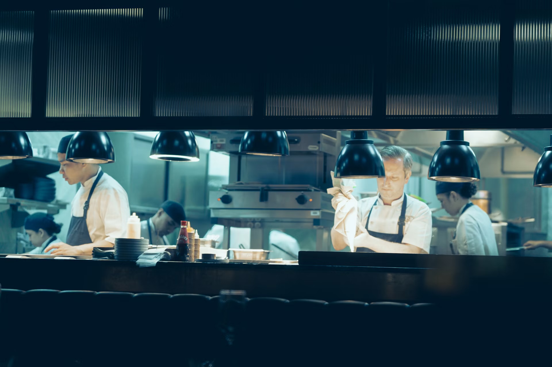 Chefs preparing food in a professional kitchen